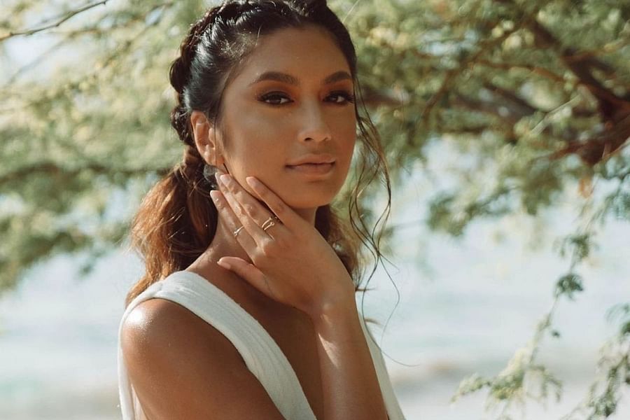 Person meditating with throat chakra crystal